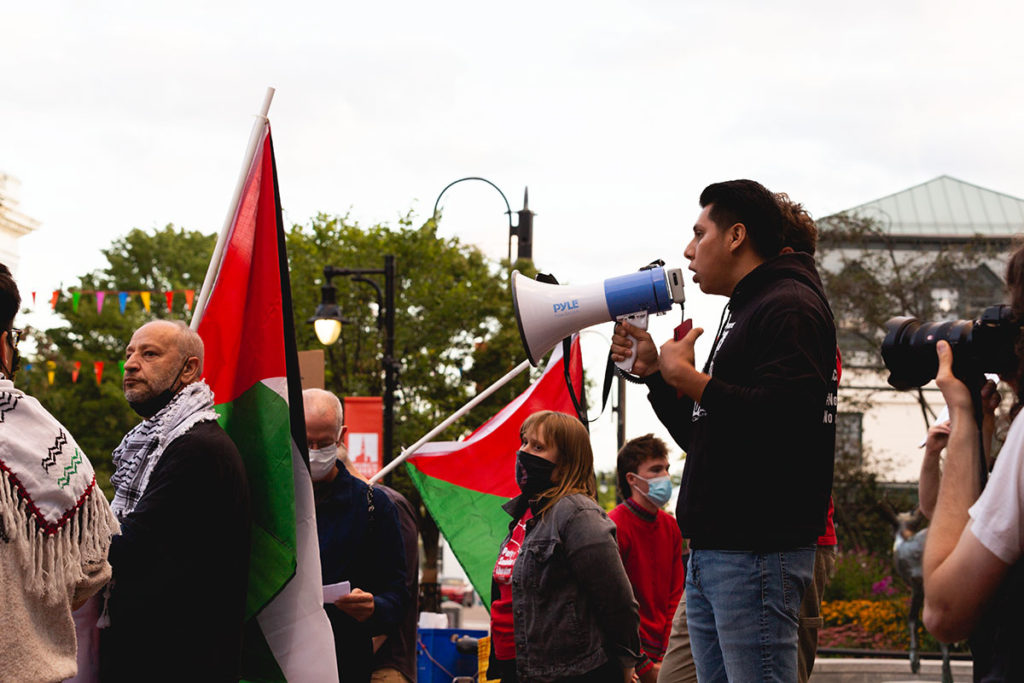 Enrique Balcazar speaks to roughly one hundred people at a pre-meeting rally at city hall in Burlington, VT on September 13, 2021.